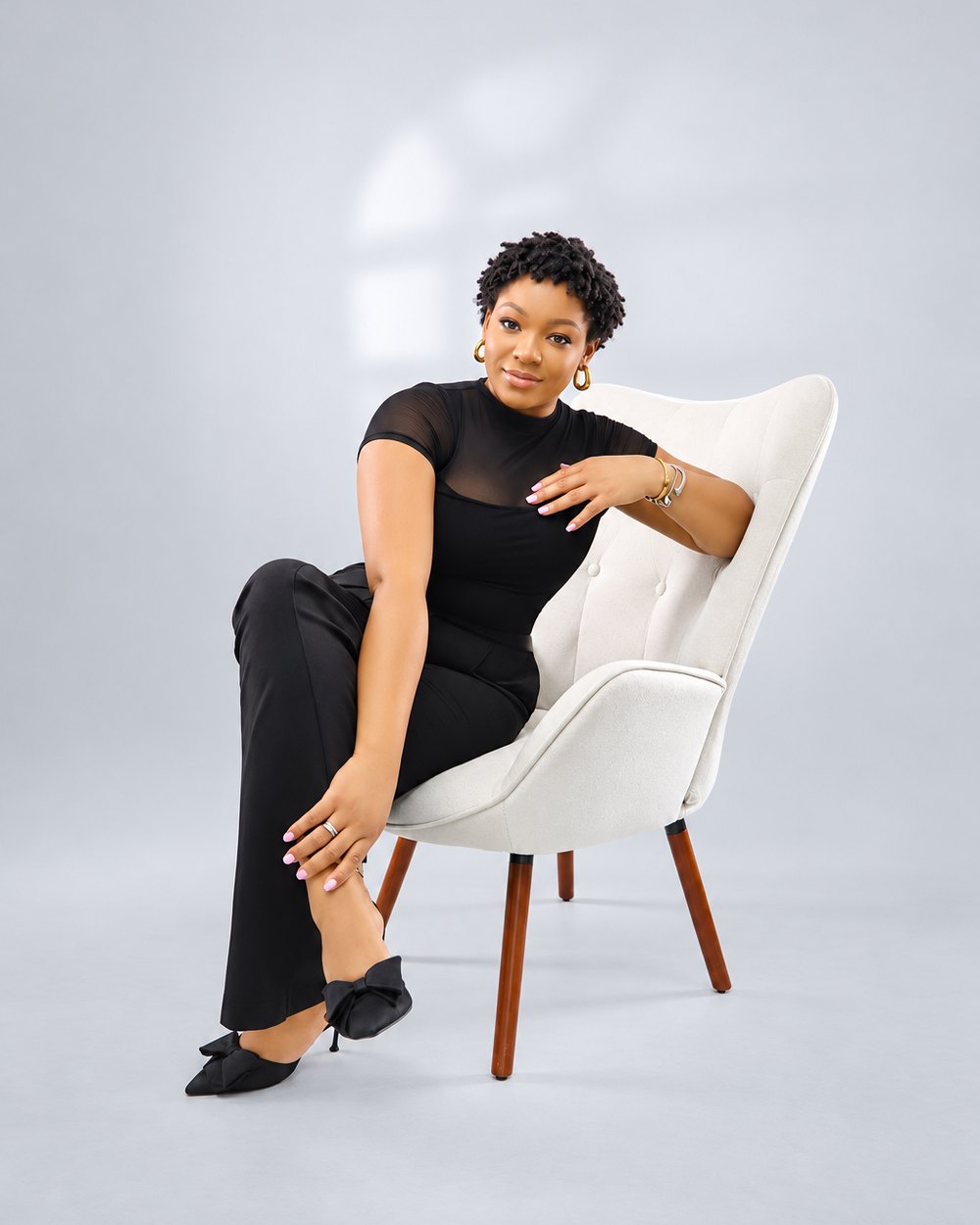 Alayha Swaby, founder of Coast to Toast JA, seated in a studio portrait.